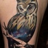 Mystical multicolored thigh tattoo of owl stylized with space