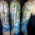 Natural colored large shoulder tattoo of bamboo with waves
