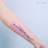 Natural colored small beautiful flowers tattoo on forearm
