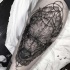 Natural looking black ink bison head tattoo on leg combined with mystical ornaments