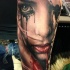 Natural looking colored arm tattoo of crying woman face