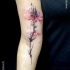 Natural looking colored arm tattoo of big flower