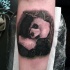 Natural looking colored forearm tattoo of cute little panda
