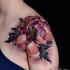 Natural looking colored shoulder tattoo of big flower