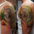 Natural looking colored shoulder tattoo of ancient Egypt God