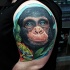 Natural looking colored shoulder tattoo of funny monkey face