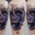 Natural looking colored thigh tattoo of octopus