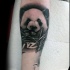 Natural looking forearm tattoo of sweet looking eating panda