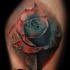 Natural looking realism style thigh tattoo of gorgeous rose