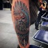 Neo traditional style colored Indian bird with wings tattoo on leg