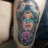 Neo traditional style colored thigh tattoo of woman with wolf helmet and rose