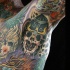 New school style colored arm tattoo of skeleton in helmet