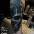 New school style colored arm tattoo of human skull stylized with cemetery