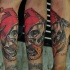 New school style colored arm tattoo of human skull with snake and red hat