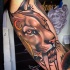 New school style colored biceps tattoo of ancient lion with ancient cat