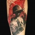 New school style colored forearm tattoo of woman with helmet and gun