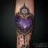 New school style colored heart shaped diamond tattoo on forearm with flower