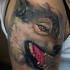 New school style colored shoulder tattoo of natural looking wolf