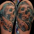 New school style colored shoulder tattoo of human skull and bones
