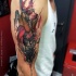 New school style colored sleeve tattoo of Egypt God with small heart