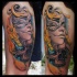 New school style colored thigh tattoo of woman face and skull