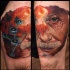 New school style colored thigh tattoo of Einstein face with atoms