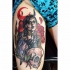 New school style colored thigh tattoo of devils woman with flowers and skull