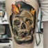 New school style colored thigh tattoo of corrupted human skull with butterflies