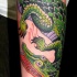 Nice cartoon like colored big detailed alligator tattoo on arm