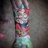 Nice cartoon style colored arm tattoo of old daruma doll
