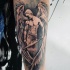 Nice looking abstract black and white angel tattoo on forearm with burning sword