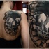 Tatuaje en la espalda, cráneo oscuro volumétrico con reloj