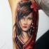 Nice looking colored biceps tattoo of beautiful woman with flower