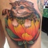 Nice looking homemade style thigh tattoo of maneki neko japanese lucky cat with small flower