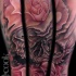 Nice looking illustrative style forearm tattoo of human skull with roses