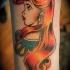Old school looking colored arm tattoo of Ariel mermaid