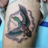 Old school style colored flying wild duck tattoo