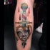 Old school style colored leg tattoo of dagger with rope and woman face