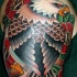 Old school style colored shoulder tattoo of typical eagle with flowers
