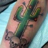 Old school style colored tattoo of cactus with arrows and skulls