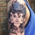 Old school style creepy looking woman with blue flowers tattoo on shoulder stylized with lettering
