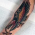Tatuaje en el antebrazo,  águila fantástica de varios colores, estilo old school