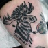 Old style designed black and white elk with arrows tattoo on thigh