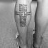 Original cross shaped black ink leg tattoo of religious lettering