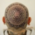 Ornamental style black ink head tattoo of awesome ornament