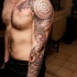 Ornamental style colored sleeve tattoo of ancient ornament