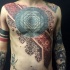 Ornamental style large chest and belly tattoo of various ornaments