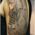 Pharaoh with power symbols tattoo on arm