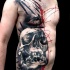 Photoshop style colored chest and belly tattoo of human skull