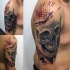 Photoshop style colored shoulder tattoo of human skull with big clock